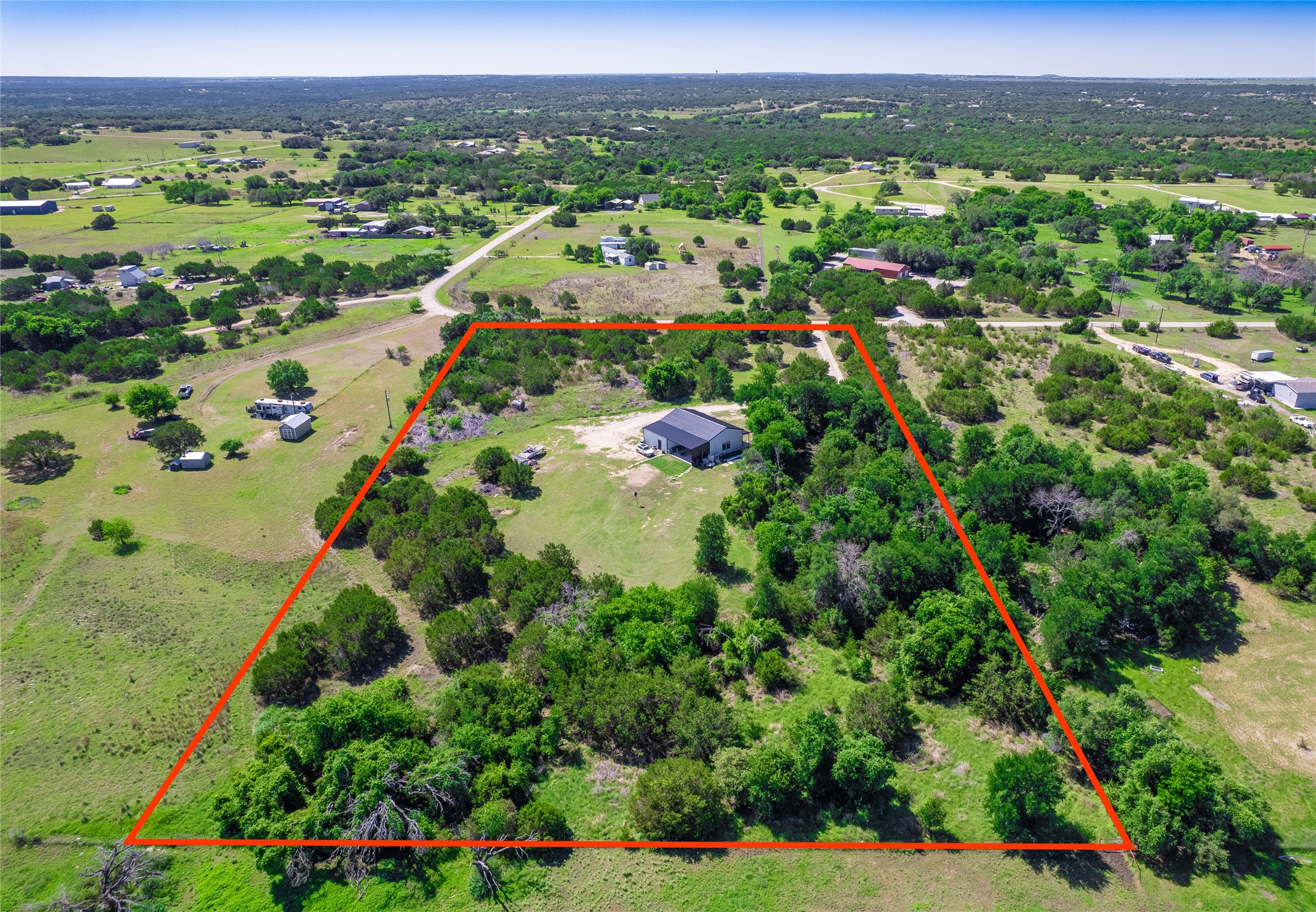 411 Avila Lane Briggs, TX 78608 - Photo 36 of 39 a view of a city with lush green forest