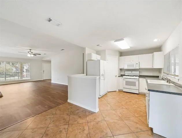 a kitchen with stainless steel appliances a refrigerator sink and cabinets