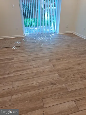 a view of a room with wooden floor