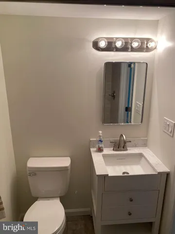 a bathroom with a toilet sink and mirror