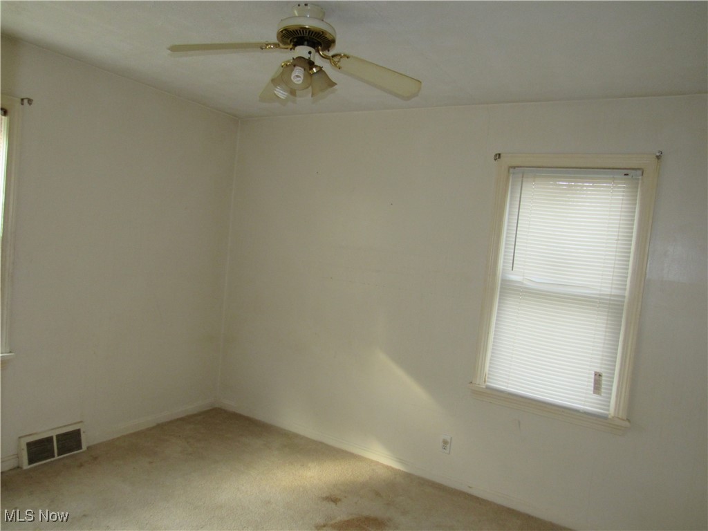 4550 Effie Road Cleveland, OH 44105 - Photo 8 of 29 Carpeted spare room with plenty of natural light and a ceiling fan