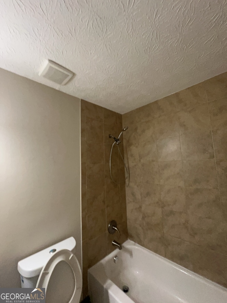 1265 Herrington Road Lawrenceville, GA 30044 - Photo 29 of 52 a bathroom with a toilet and a bathtub