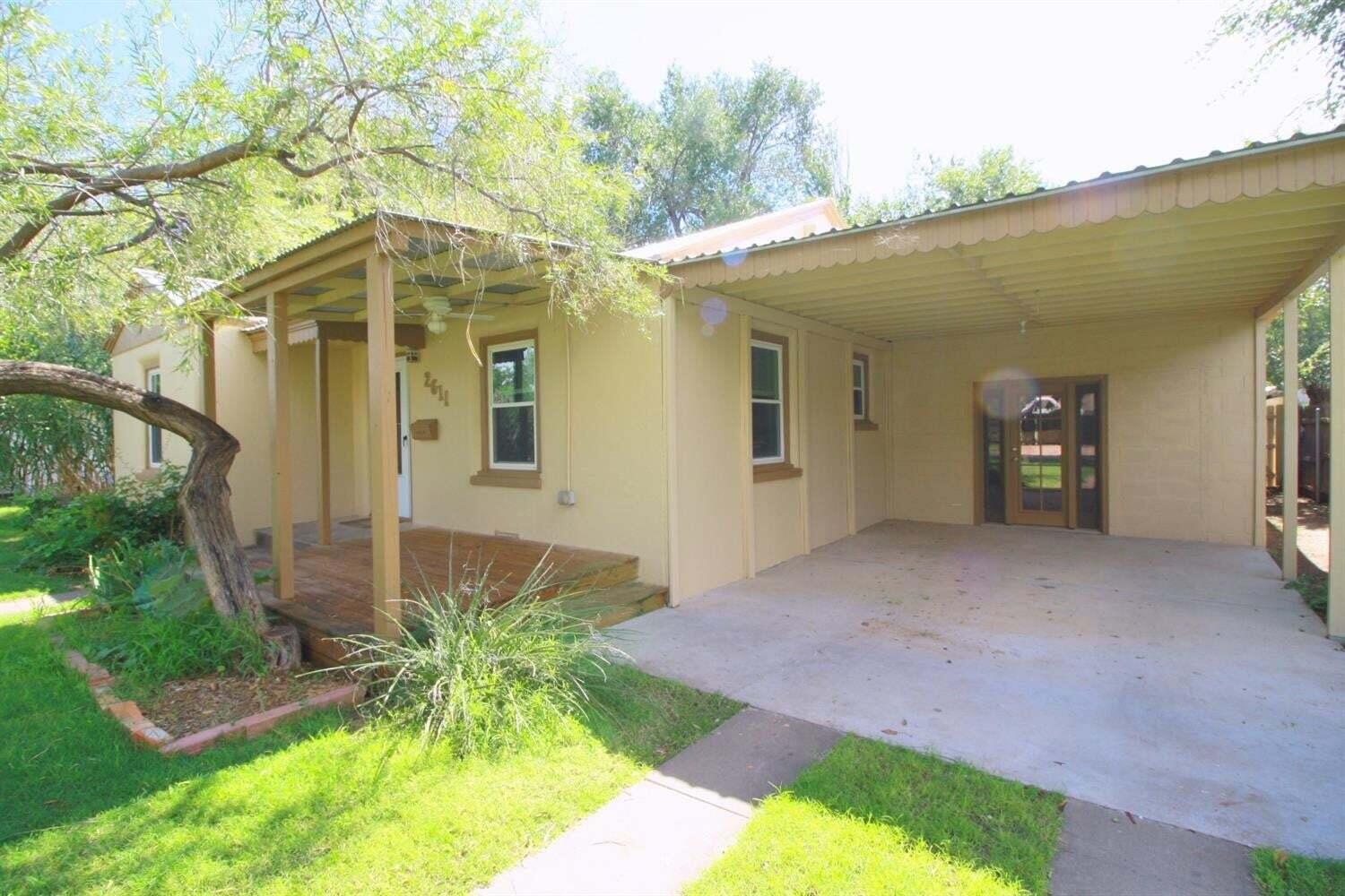 2611 28th Street Lubbock, TX 79410 - Photo 1 of 22 a front view of a house with garden