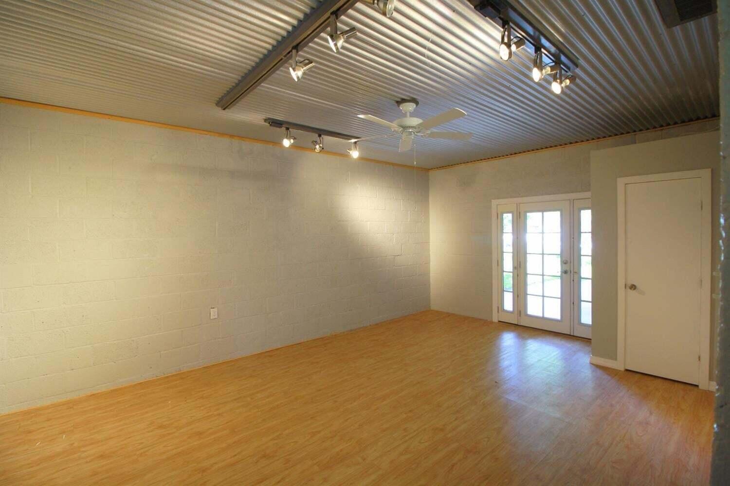 2611 28th Street Lubbock, TX 79410 - Photo 12 of 22 an empty room with wooden floor and windows