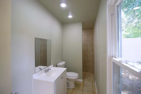 a bathroom with a sink mirror and toilet