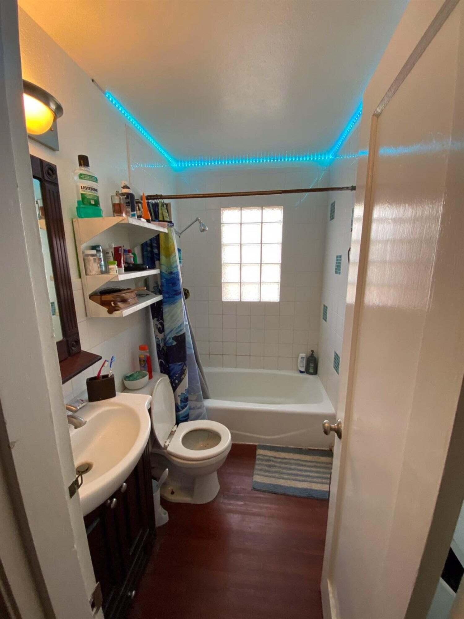 2611 28th Street Lubbock, TX 79410 - Photo 18 of 22 a bathroom with a sink a toilet and a bathtub