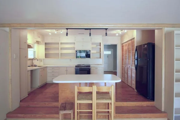 a kitchen with a refrigerator and countertop