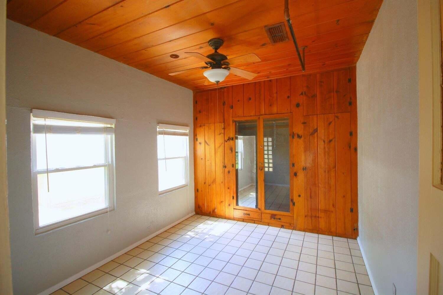 2611 28th Street Lubbock, TX 79410 - Photo 9 of 22 a view of an empty room with window and chandelier fan