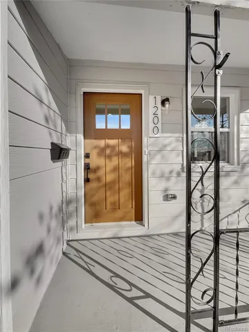 a view of a hallway with wooden floor and a bathroom shower