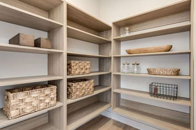 a view of walk in closet with empty racks