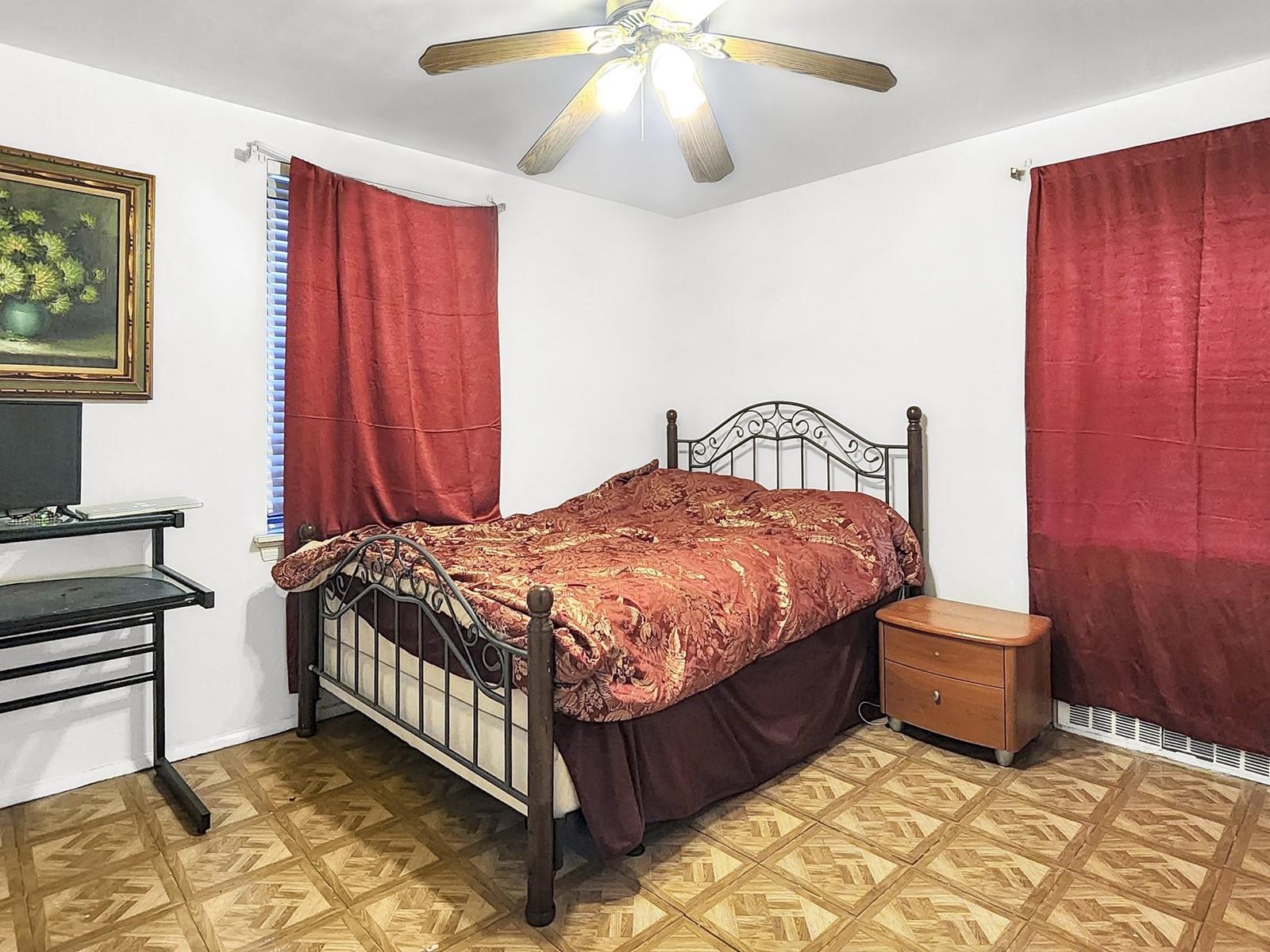 139-15 28th Road, Unit 1F Queens, NY 11354 - Photo 5 of 6 Bedroom featuring parquet floors and ceiling fan