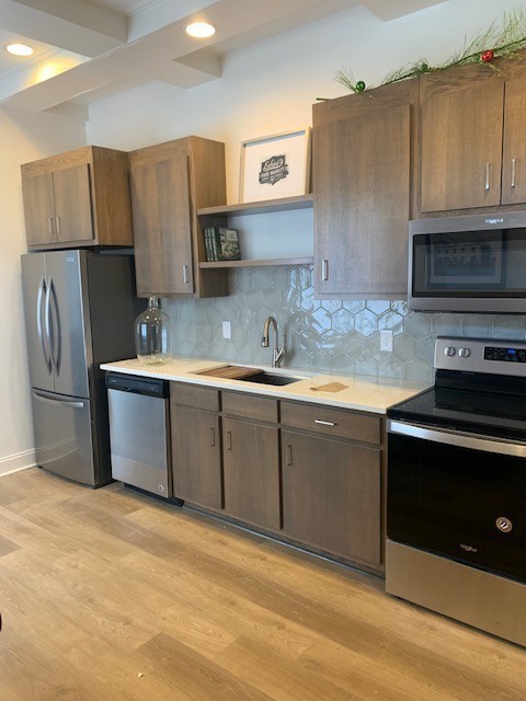 326 West Main Street, Unit 1 Lebanon, TN 37087 - Photo 17 of 63 a kitchen with stainless steel appliances granite countertop a refrigerator a stove a sink and a microwave