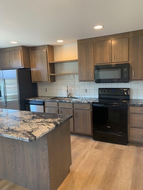 326 West Main Street, Unit 1 Lebanon, TN 37087 - Photo 41 of 63 a kitchen with stainless steel appliances granite countertop a stove a sink and a refrigerator