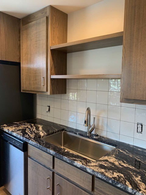 326 West Main Street, Unit 1 Lebanon, TN 37087 - Photo 43 of 63 a kitchen with granite countertop a sink stainless steel appliances and cabinets