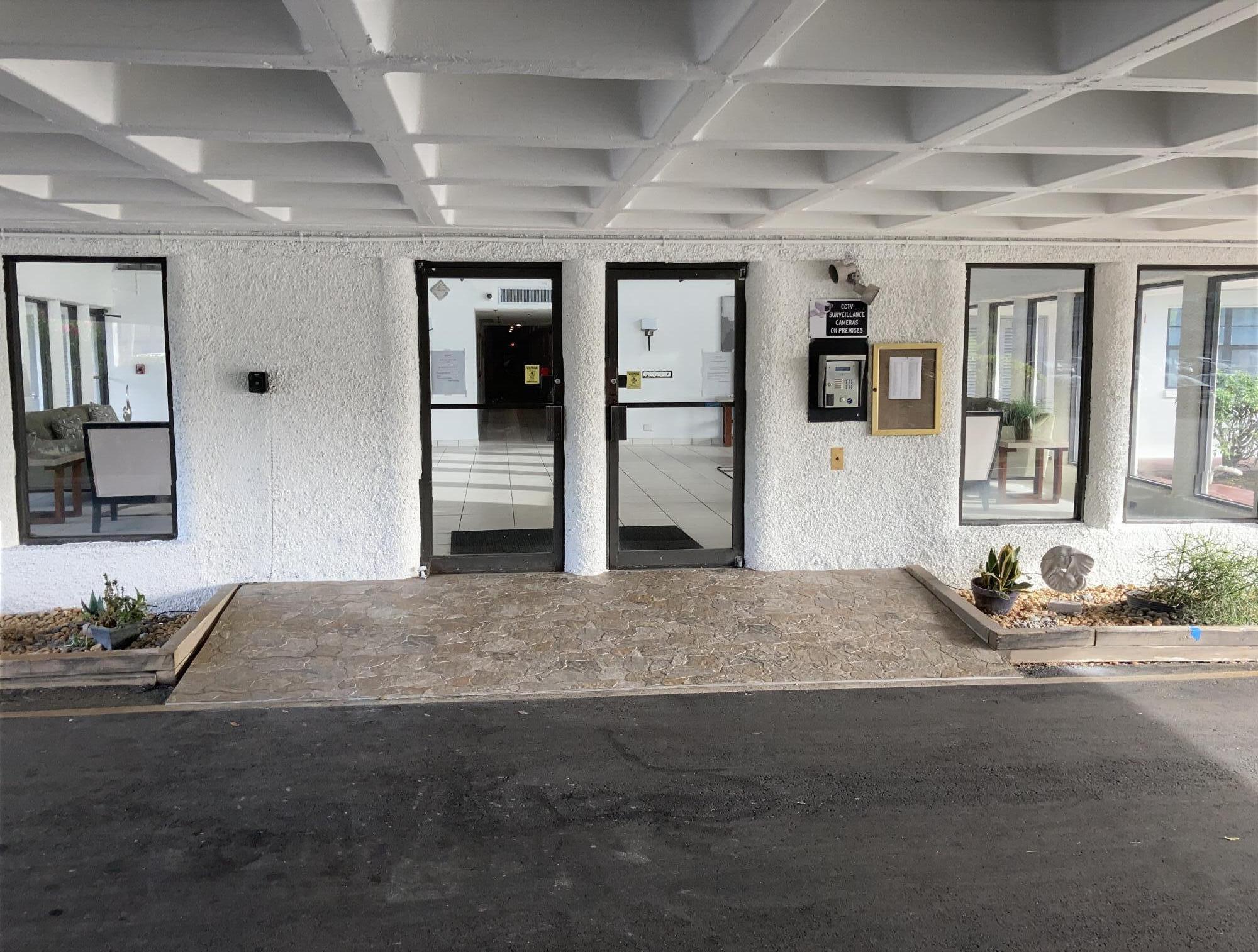 9233 Southwest 8th Street, Unit 305 Boca Raton, FL 33428 - Photo 45 of 48 9233 Covered Front Lobby