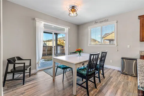 a large kitchen with a table and chairs