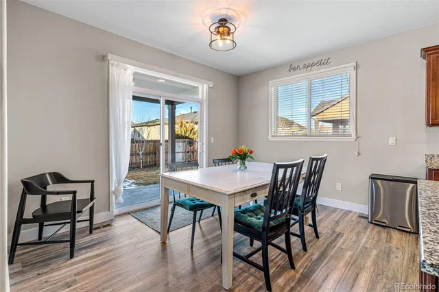 a large kitchen with a table and chairs