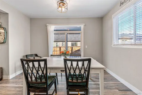 a view of a dining room with furniture and window