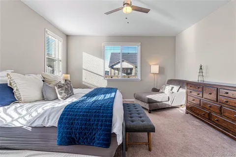 a bedroom with a bed a couch and dresser