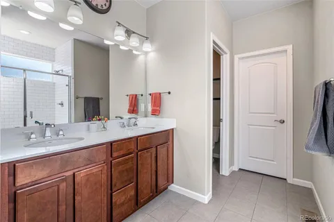 a bathroom with a double vanity sink and a mirror