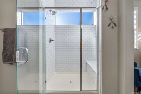 a bathroom with a glass shower door