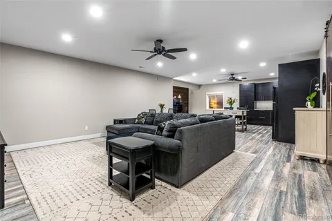 a living room with furniture and kitchen view