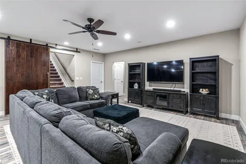 a large kitchen with stainless steel appliances a large counter top a stove and a chandelier