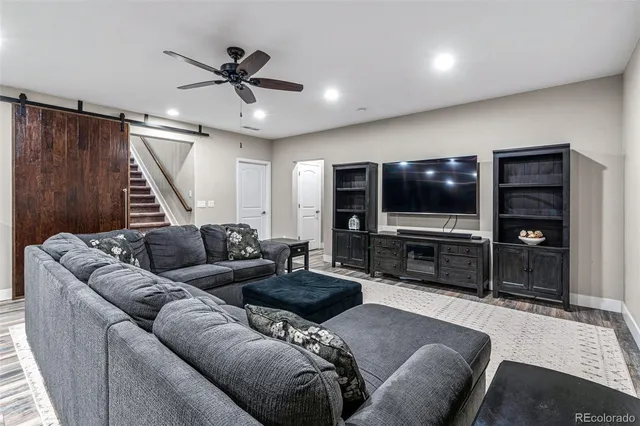 a large kitchen with stainless steel appliances a large counter top a stove and a chandelier