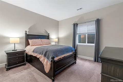 a spacious bedroom with a bed and a window