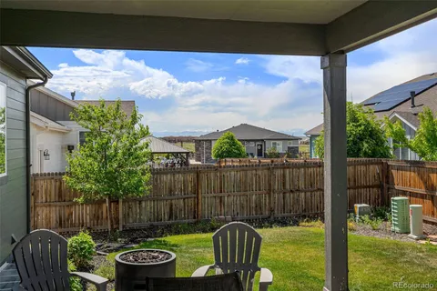 a view of a chair and table in backyard