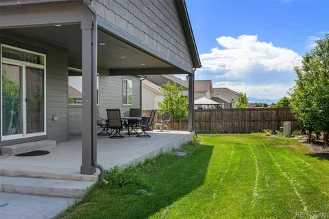 a view of a backyard with a sitting area and a garden