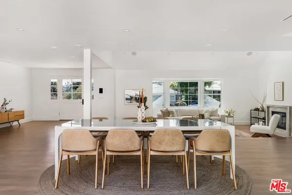 a dining room with furniture and wooden floor