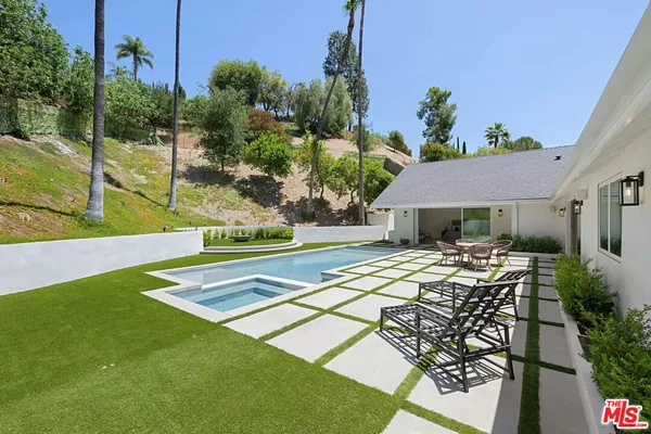 a view of a patio with table and chairs potted plants with wooden floor