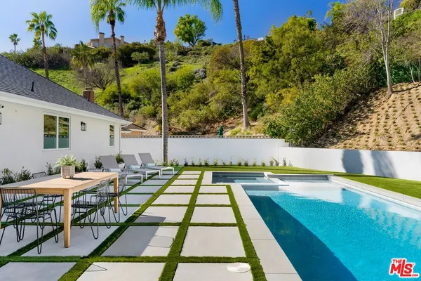 a view of swimming pool with seating space