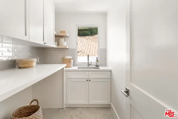 a kitchen with a sink and cabinets