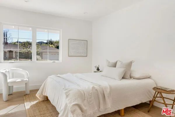 a bedroom with a bed and glass window