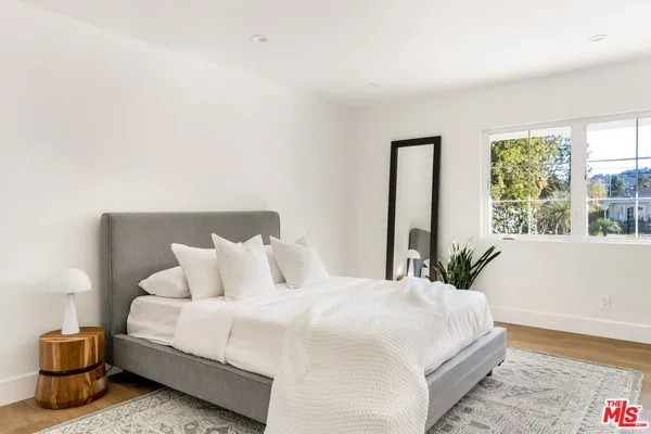 a bedroom with a bed and window