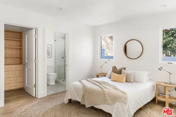 a bedroom with a bed and a chandelier