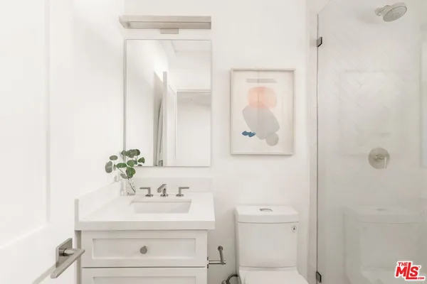 a bathroom with a sink mirror and vanity