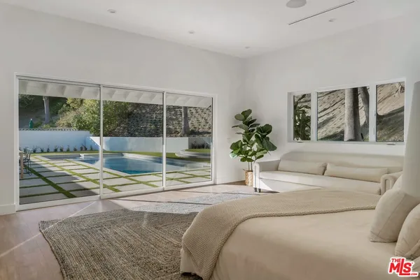 a bedroom with a bed and glass window