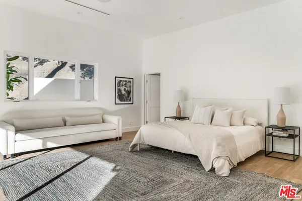 a bedroom with a bed and a couch