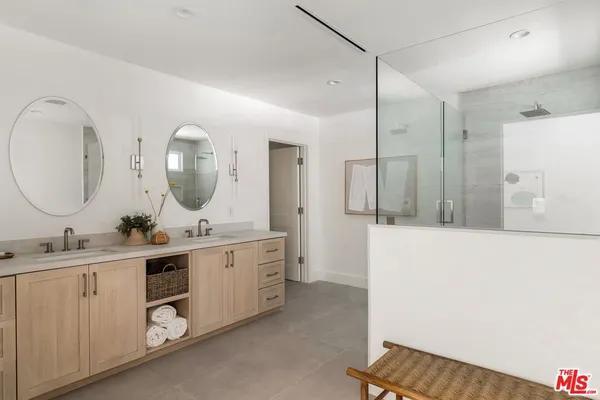 a bathroom with a double vanity sink and a mirror