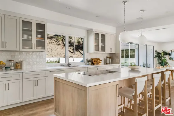 a kitchen with stainless steel appliances granite countertop a sink and cabinets