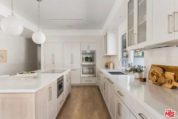 a kitchen that has a lot of counter space and a sink