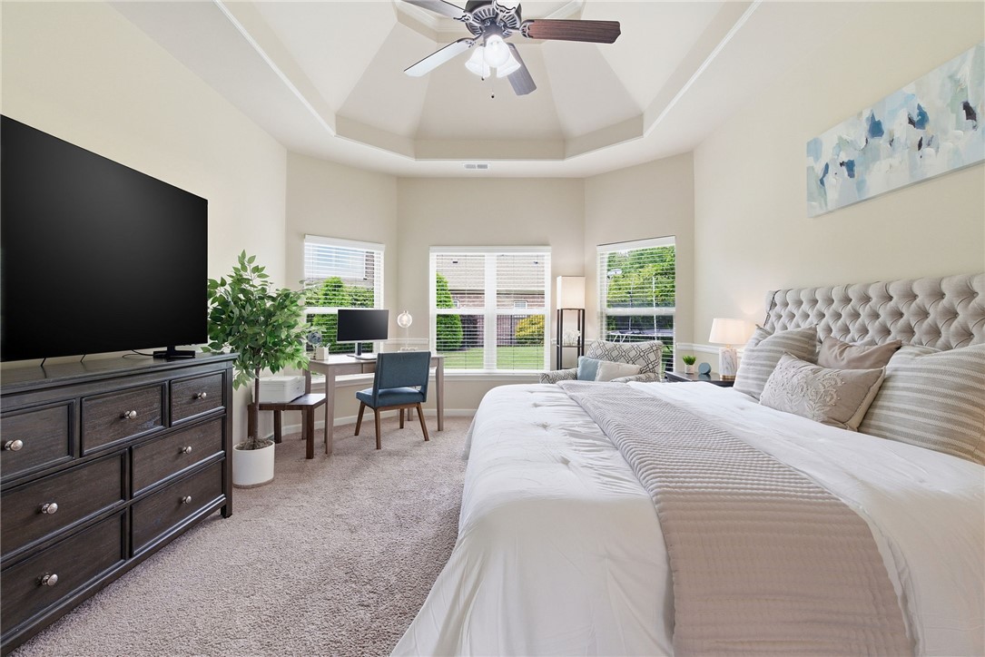 138 Buckland Drive Anderson, SC 29621 - Photo 21 of 49 This spacious primary bedroom features a striking tray ceiling and bright bay windows.