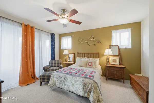 a spacious bedroom with a bed and furniture