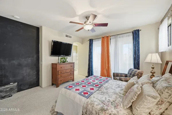 a large bedroom with a bed and a chandelier