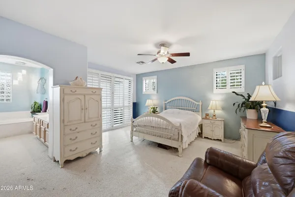 a bedroom with a bed and a chandelier