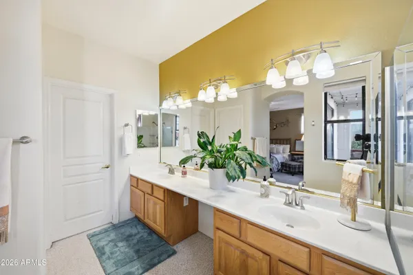 a spacious bathroom with a double vanity sink and a mirror