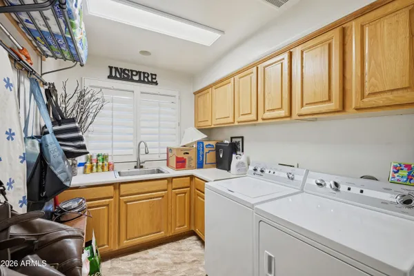 a view of a patio with table and chairs under an umbrella